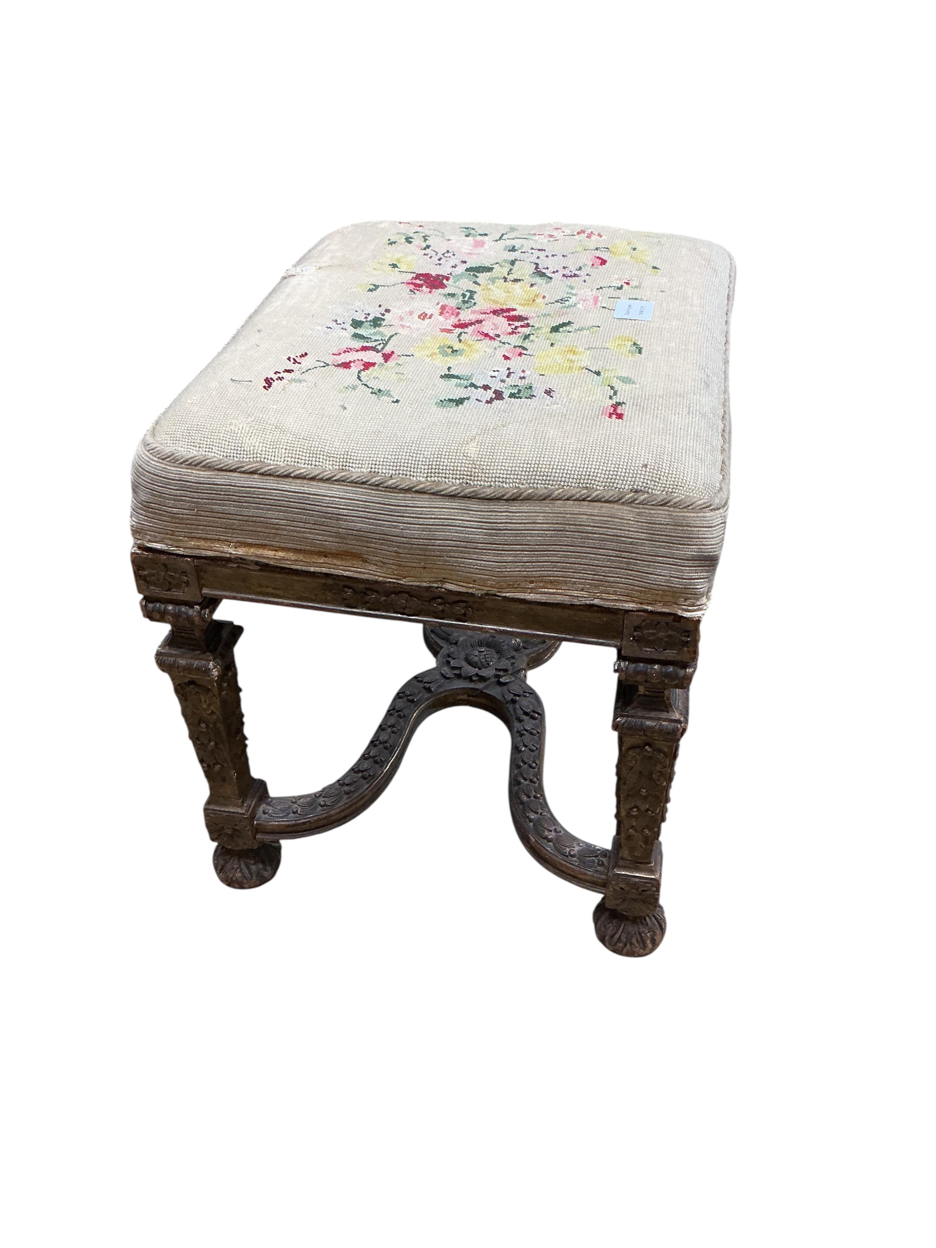 A 19th century carved giltwood dressing stool with shaped 'X' stretcher, width 56cm, depth 43cm, height 49cm